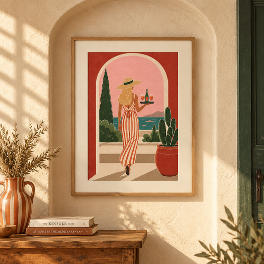 Art print of a woman in a striped linen dress carrying a tray of wine through an archway onto a coastal terrace at sunset