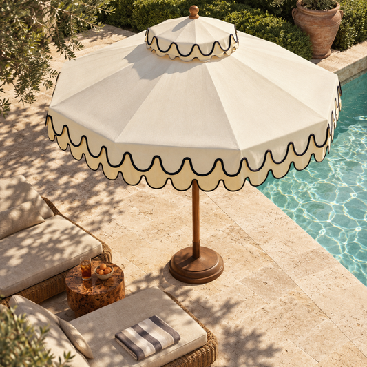 The Riviera two-tier cream garden parasol with wavy navy scalloped trim