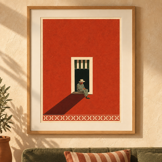 Art print of a figure in a striped suit and straw hat sitting in a shaded window in a terracotta wall